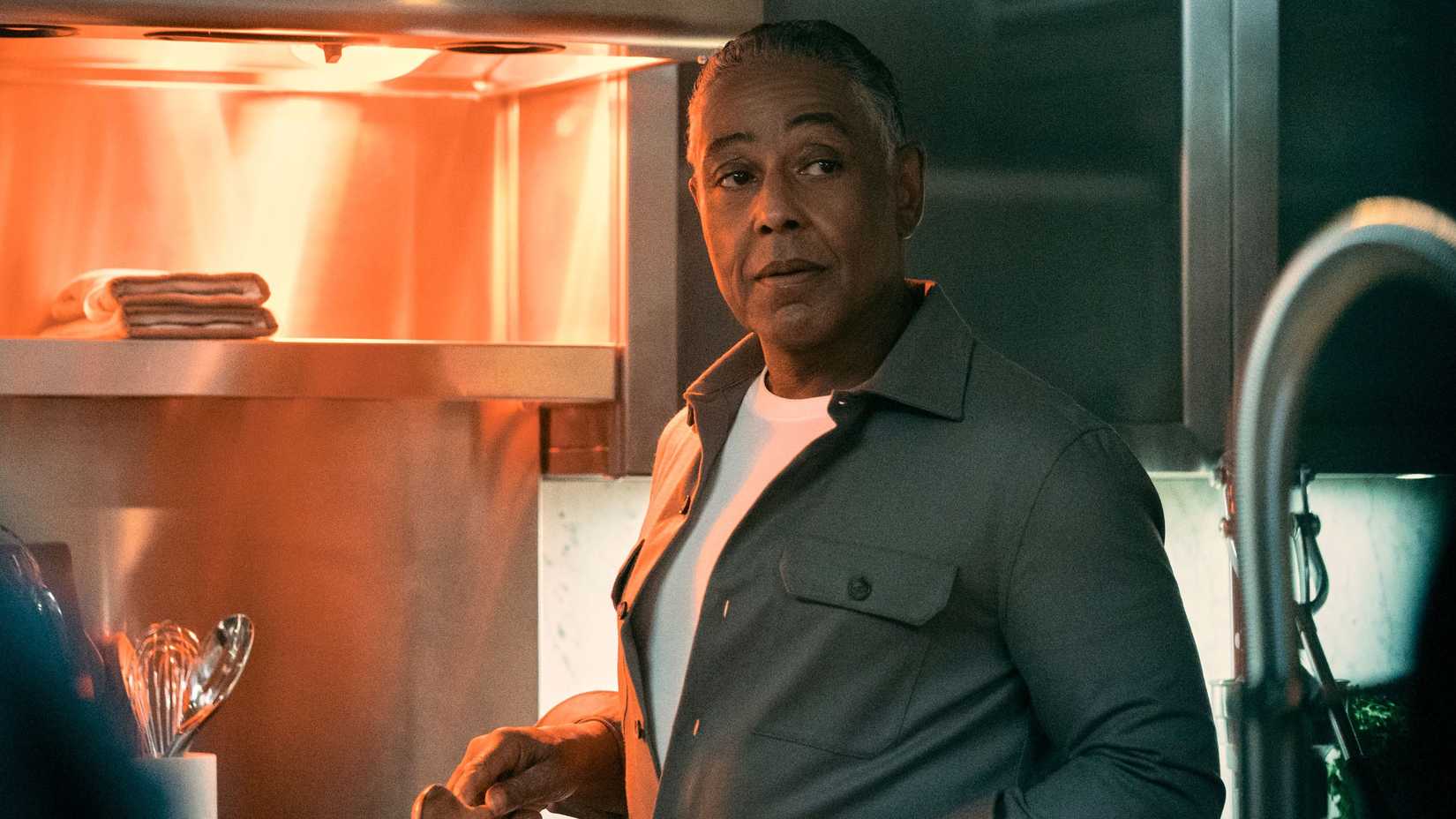 Giancarlo Esposito as Stan Edgar cooking something in his kitchen in Gen V season 2