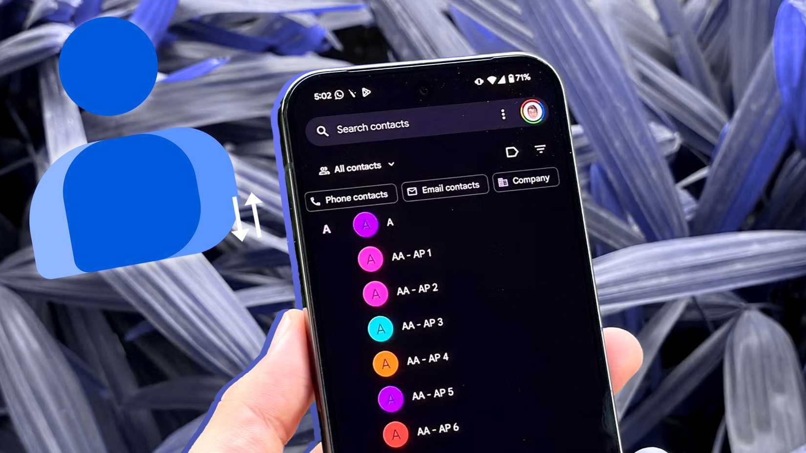 A hand holding a phone with the Google Contacts app on the screen