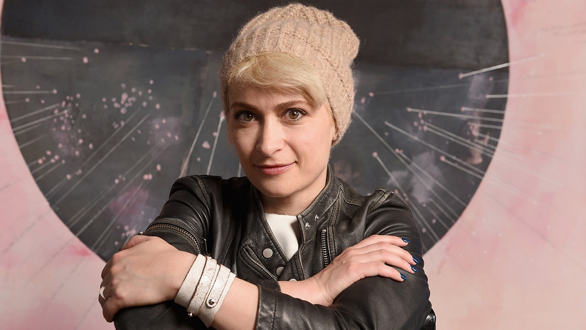 Cinematographer Halyna Hutchins posing in a leather jacket