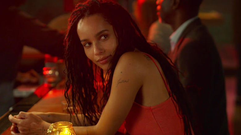 Rob standing at a bar smiling in High Fidelity