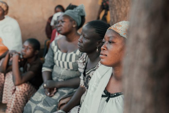 Ouagadougou, Burkina Faso, December 2017. The sub-Saharan country is struck every year by many cases of malaria, an endemic disease that represents a serious problem for the population. This image, taken during a photographic documentary, shows a group of women, from a village a few kilometers from Ouagadougou, as they attend a demonstration lesson on the use of mosquito nets against malaria. The lesson is held by a group of women belonging to a health team who periodically travels from village to village to inform the population about the risks of the disease.