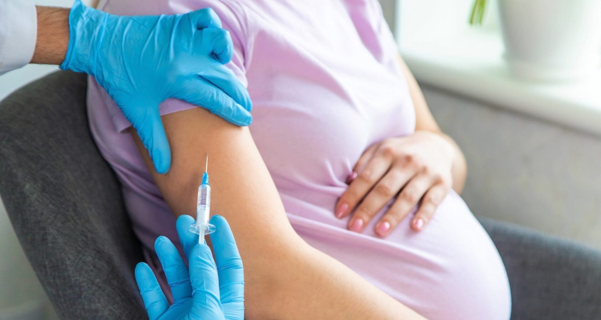 A pregnant woman makes a vaccination. Selective focus. doctor.