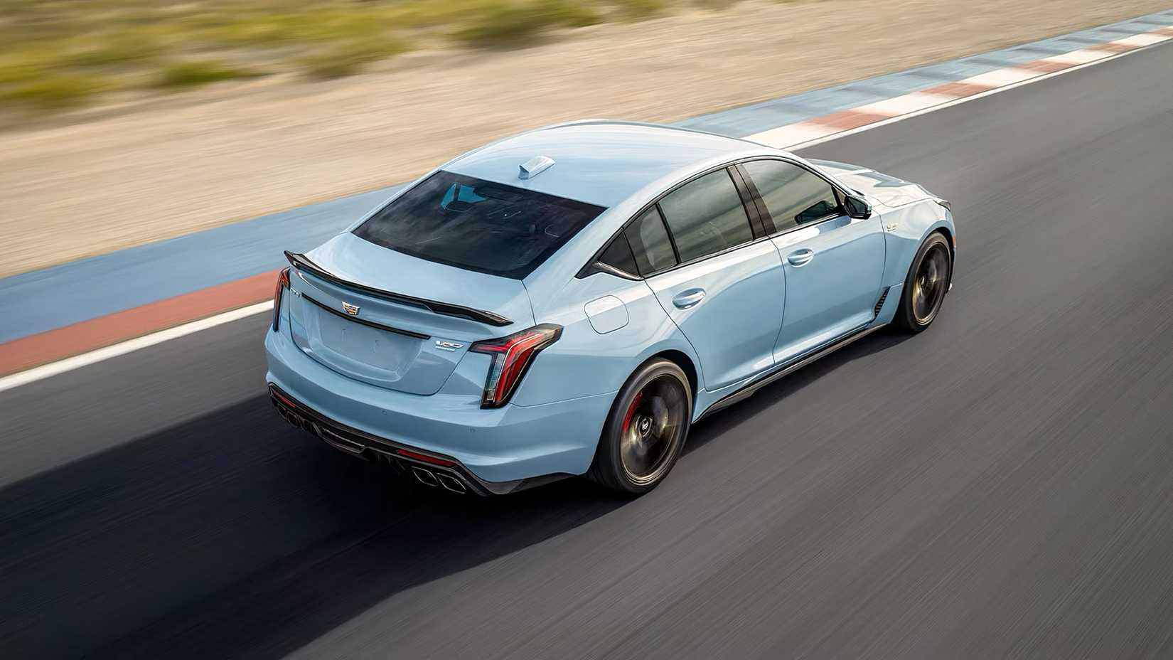 Rear ariel shot of a 2026 Cadillac CT5-V Blackwing in blue being driven