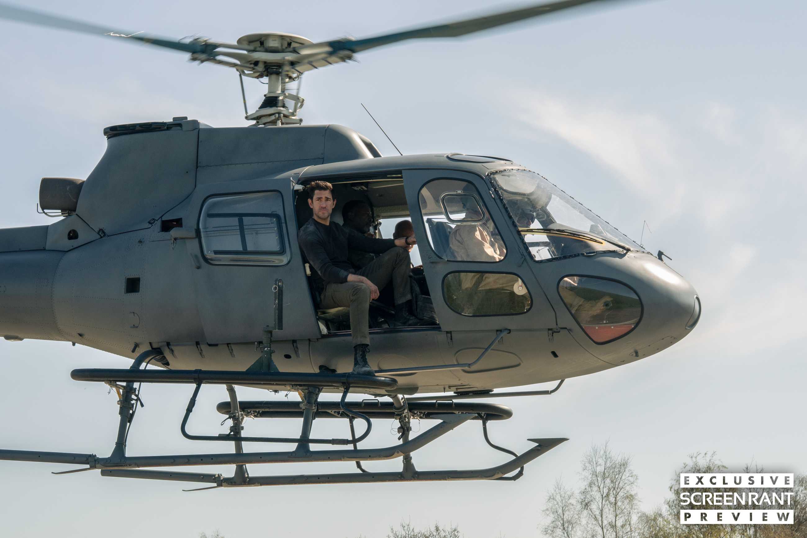 John Krasinski looking out from a helicopter door in Jack Ryan: Ghost War