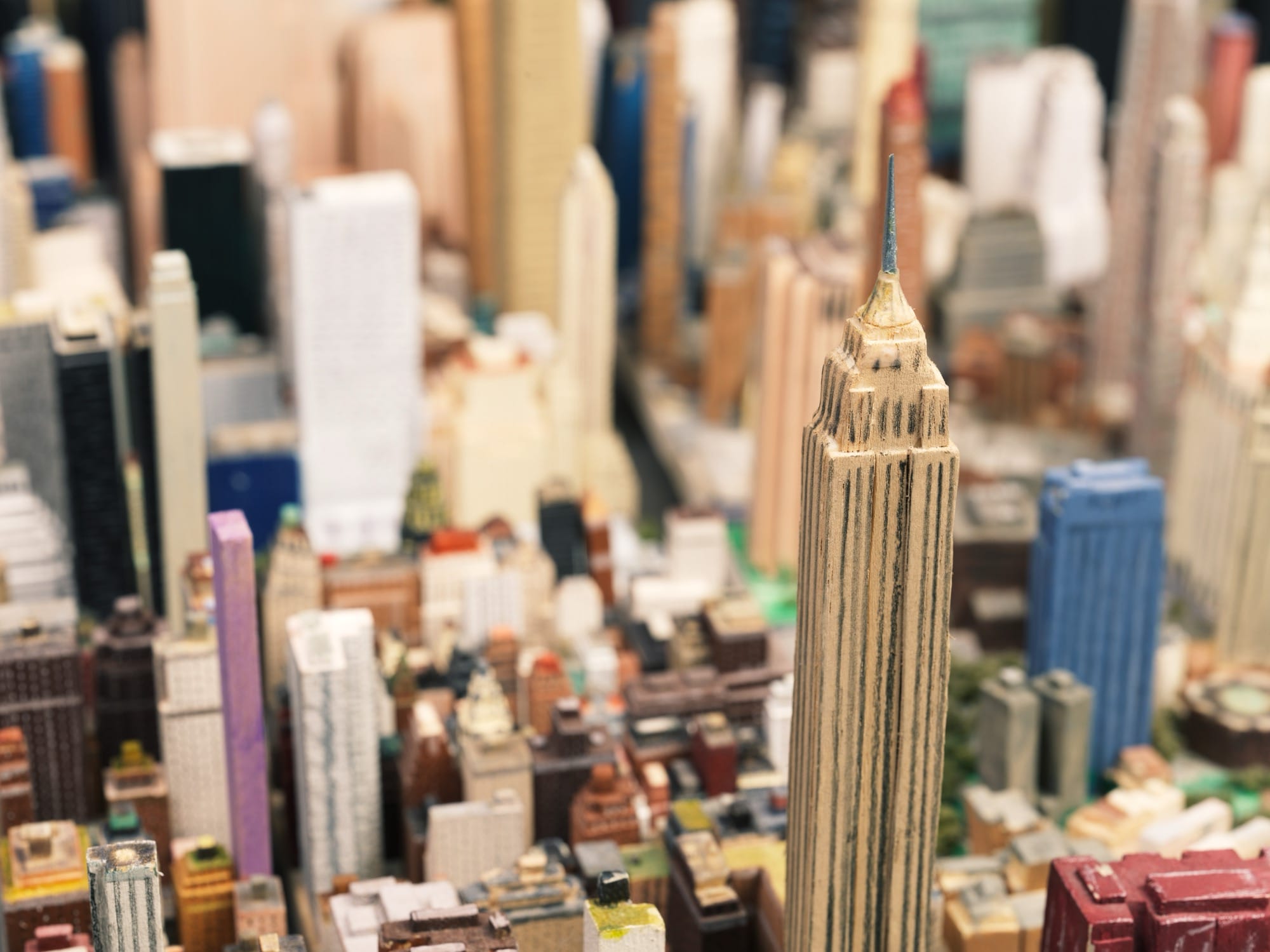 a detail of a steam ship and an expansive, hand-built scale model of New York City