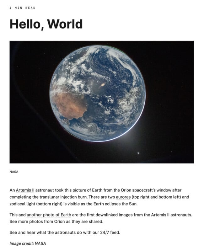 A photo of Earth taken from space by Artemis II, showing two auroras (top right and bottom left) and zodiacal light (bottom right) as the planet is partly in shadow against a black background.