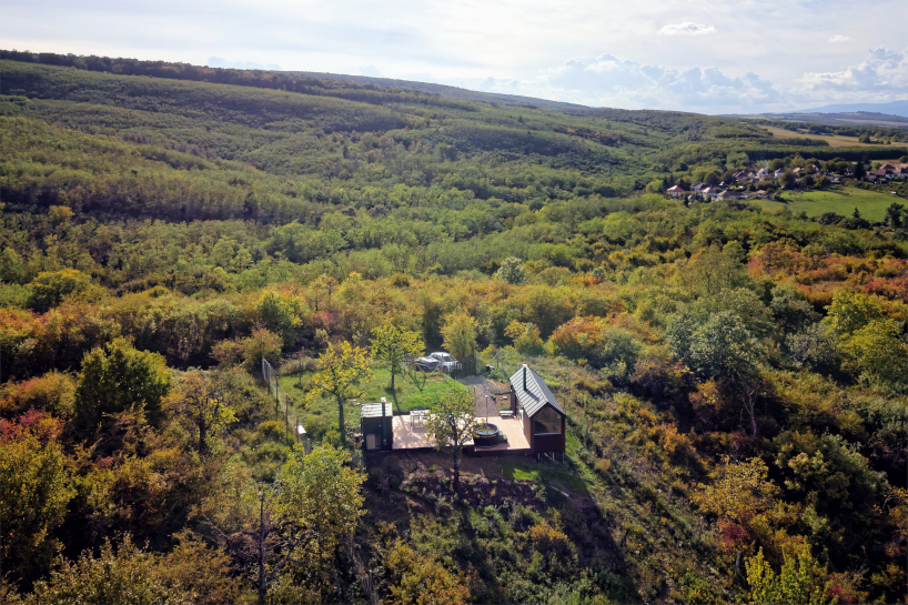 prefabricated timber micro-cabin extends living into the hungarian landscape - 2
