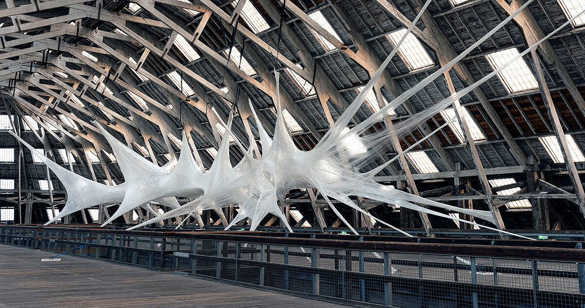 inside numen / for use's strange spaces sculpted from tape and tensioned nets