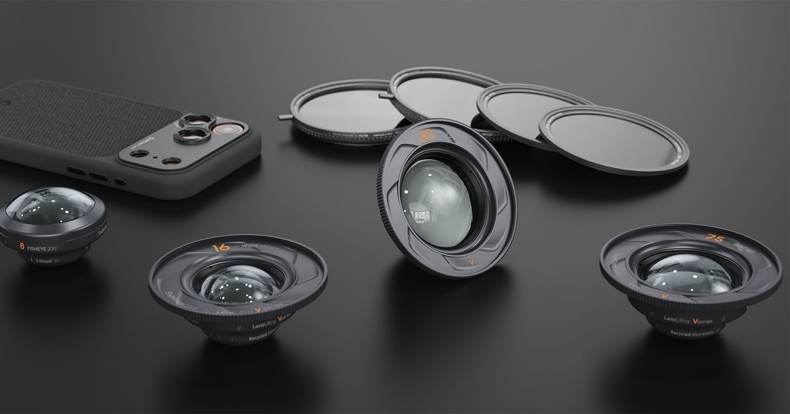 Four camera lenses, three round lens filters, and a smartphone with a textured back are arranged on a dark surface, showcasing photography accessories in a neat layout.