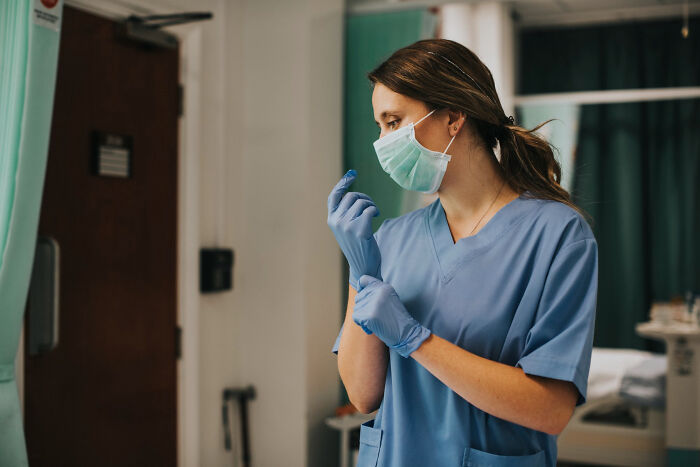 Surgical staff preparing for procedure, wearing mask and gloves, highlighting patient confessions while under sedation.