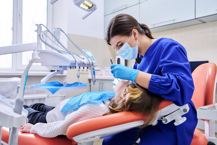 Surgical staff wearing mask and gloves treating a patient in a clinic revealing unhinged patient confessions under sedation