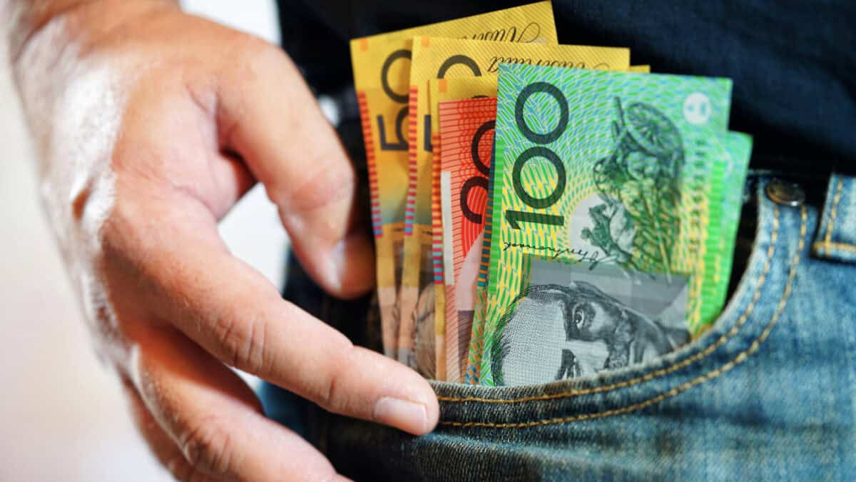 Australian dollar notes in the pocket of a man's jeans, symbolising dividends.