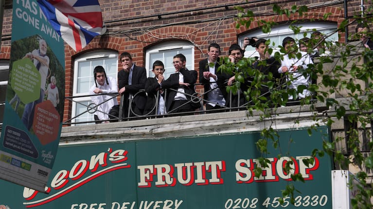People look over the area where two people were stabbed in Golders Green neighbourhood, that has a large Jewish community, in London.