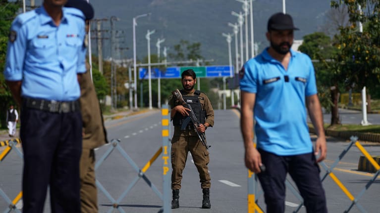 Police officers stand guard at a checkpoint ahead of the second round of negotiations between the US and Iran, in Islamabad, Pakistan, Tuesday, April 21, 2026.