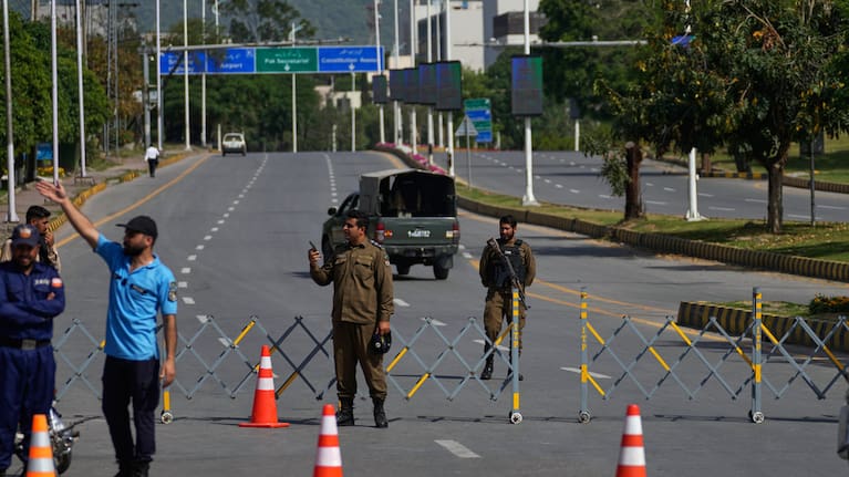 Police officers stand guard at a checkpoint ahead of the second round of negotiations between the US and Iran, in Islamabad, Pakistan, Tuesday, April 21, 2026.