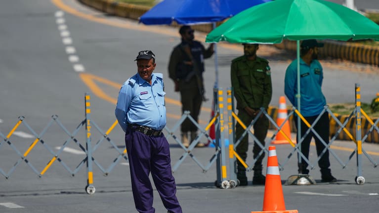 Police officers stand guard at a checkpoint to ensure security in Islamabad, Pakistan, Wednesday, April 22, 2026.