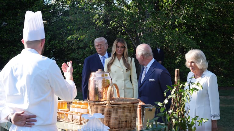 President Donald Trump and first lady Melania Trump and Britain's King Charles III and Queen Camilla talk with White House assistant pastry chef Carlo Figarella as they look at a display at the White House garden on the South Lawn of the White House.