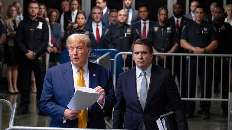 President Donald Trump, stands with then-defense attorney Todd Blanche.