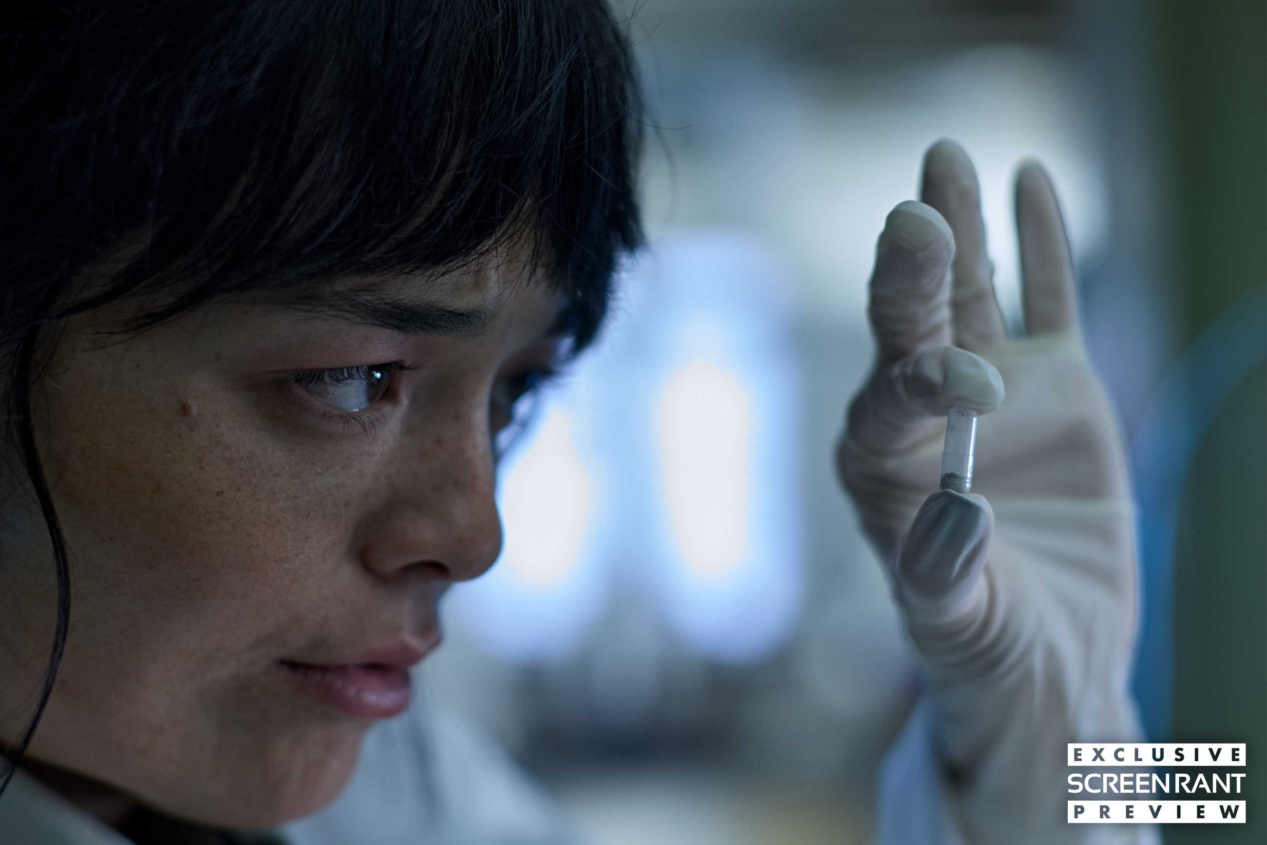 Hana stares closely at a capsule she's holding up in Saccharine