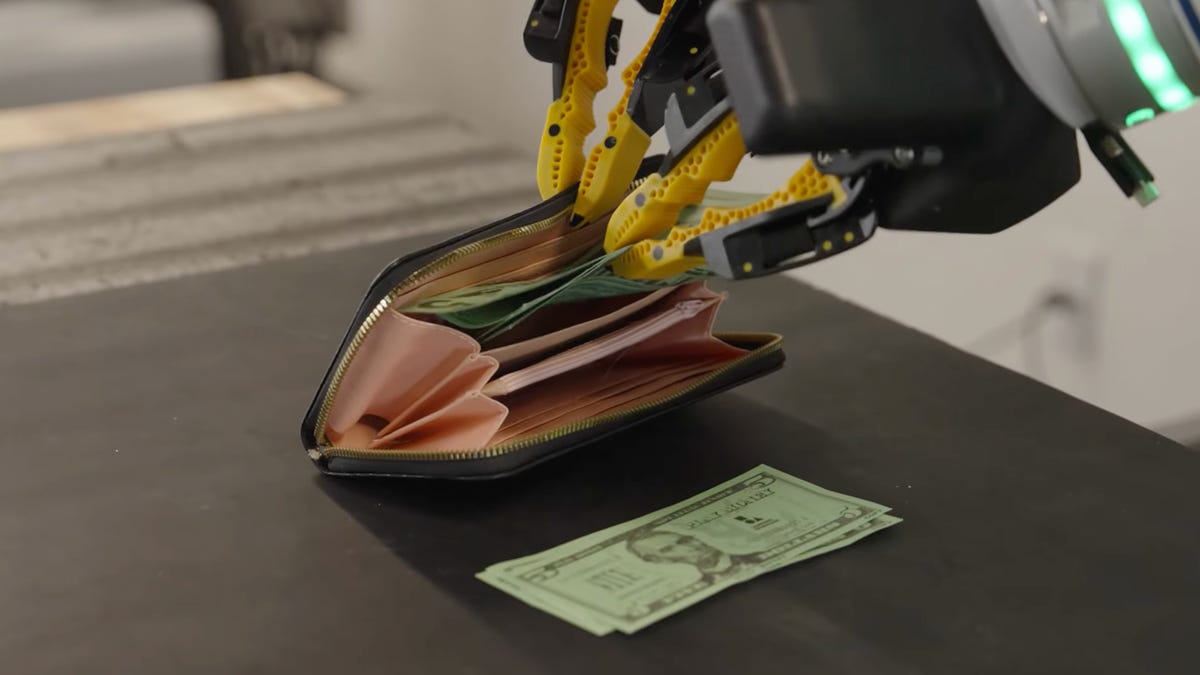 Robot hands putting money in wallet