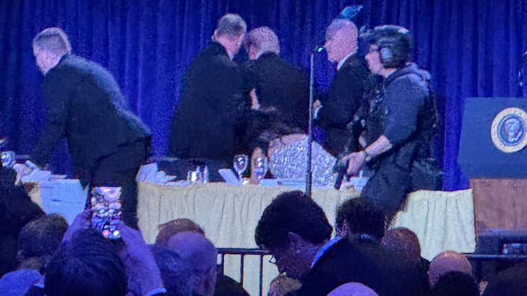 Secret Service agents surround President Donald Trump, third from left, as he is taken from the stage.