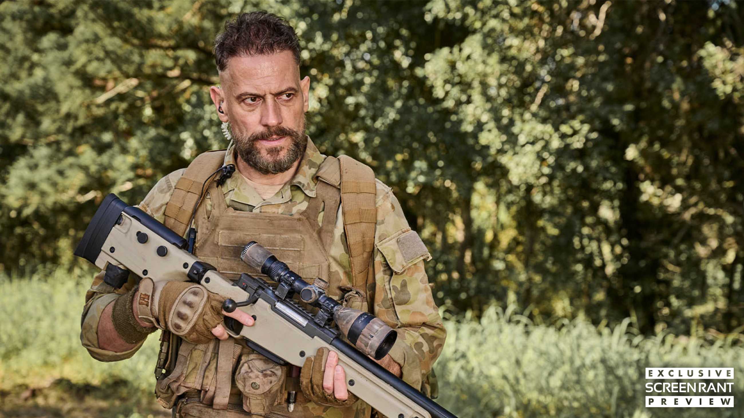 Ioan Gruffudd in camo holding a sniper rifle in Seven Snipers