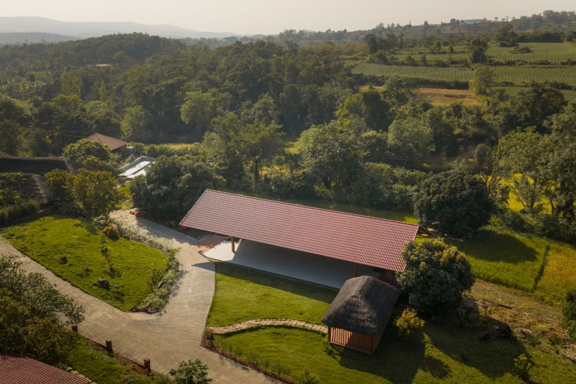 gabled roof floats over gathering pavilion’s brick stepped plinths in india - 1