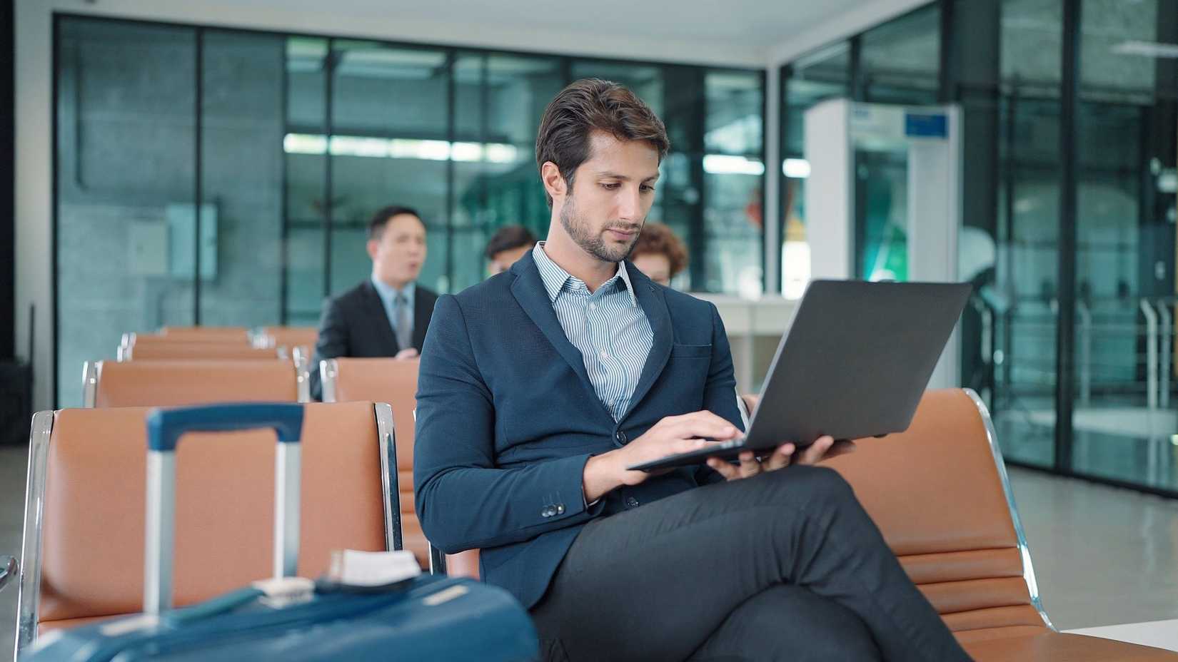 Passenger Using Laptop In Airport