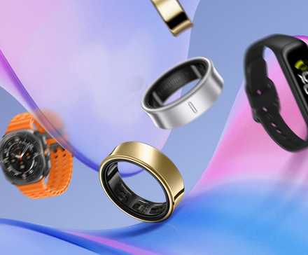 Some smartwatches on a curved surface with a smartwatch and a smart band beside them.