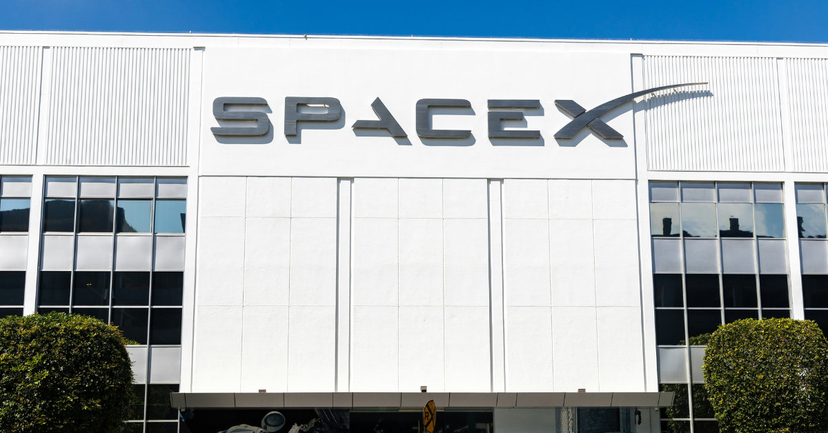 A white building with SpaceX across the front of it