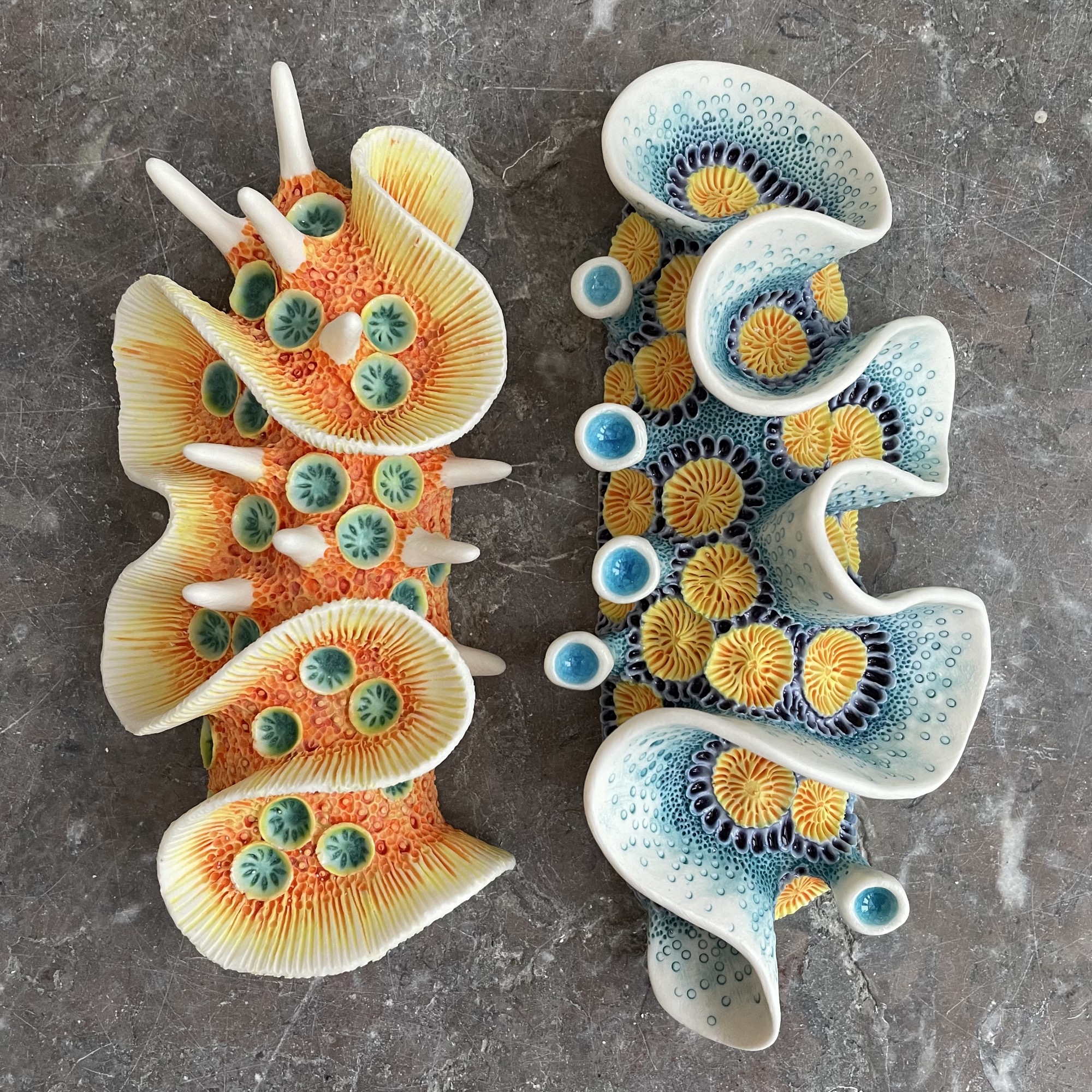 a pair of colorful, nudibranch-inspired ceramic sculptures by Lisa Stevens