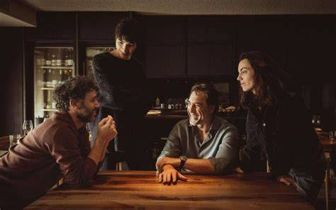 A group of four people sitting around a kitchen table
