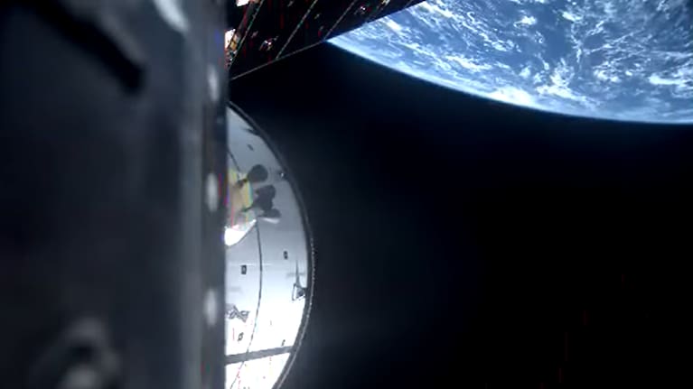 The Earth can be seen as the Orion capsule and service module orbit around the Earth. 