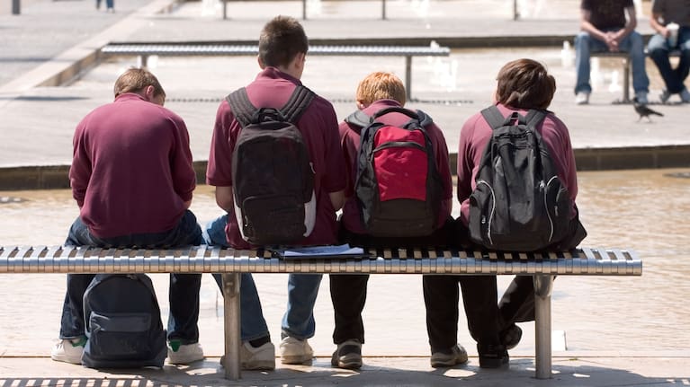 File image of teenage schoolboys sitting on a bench
