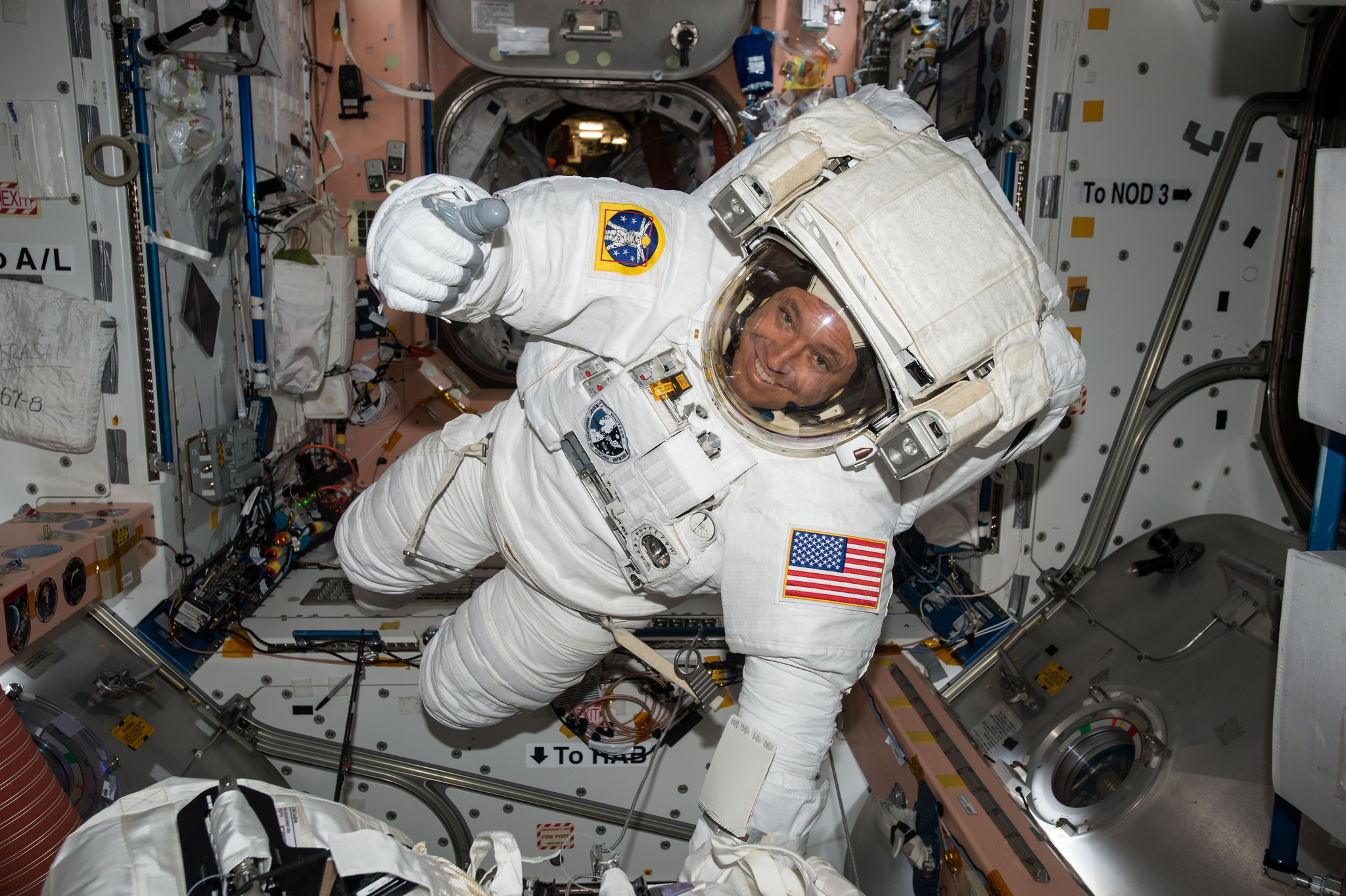 NASA astronaut Jack Fischer gives a thumbs-up sign while wearing an extravehicular mobility unit (EMU) spacesuit ahead of a May 12, 2017 spacewalk.