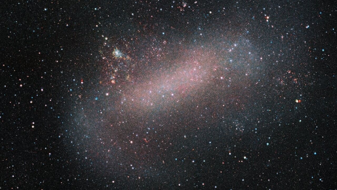 A photo of the LMC, it looks like a bundle of tiny stars against the background of space.