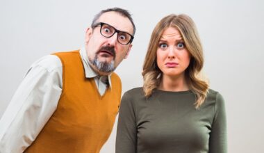 A couple is staring at the camera, looking amazed and bewildered.