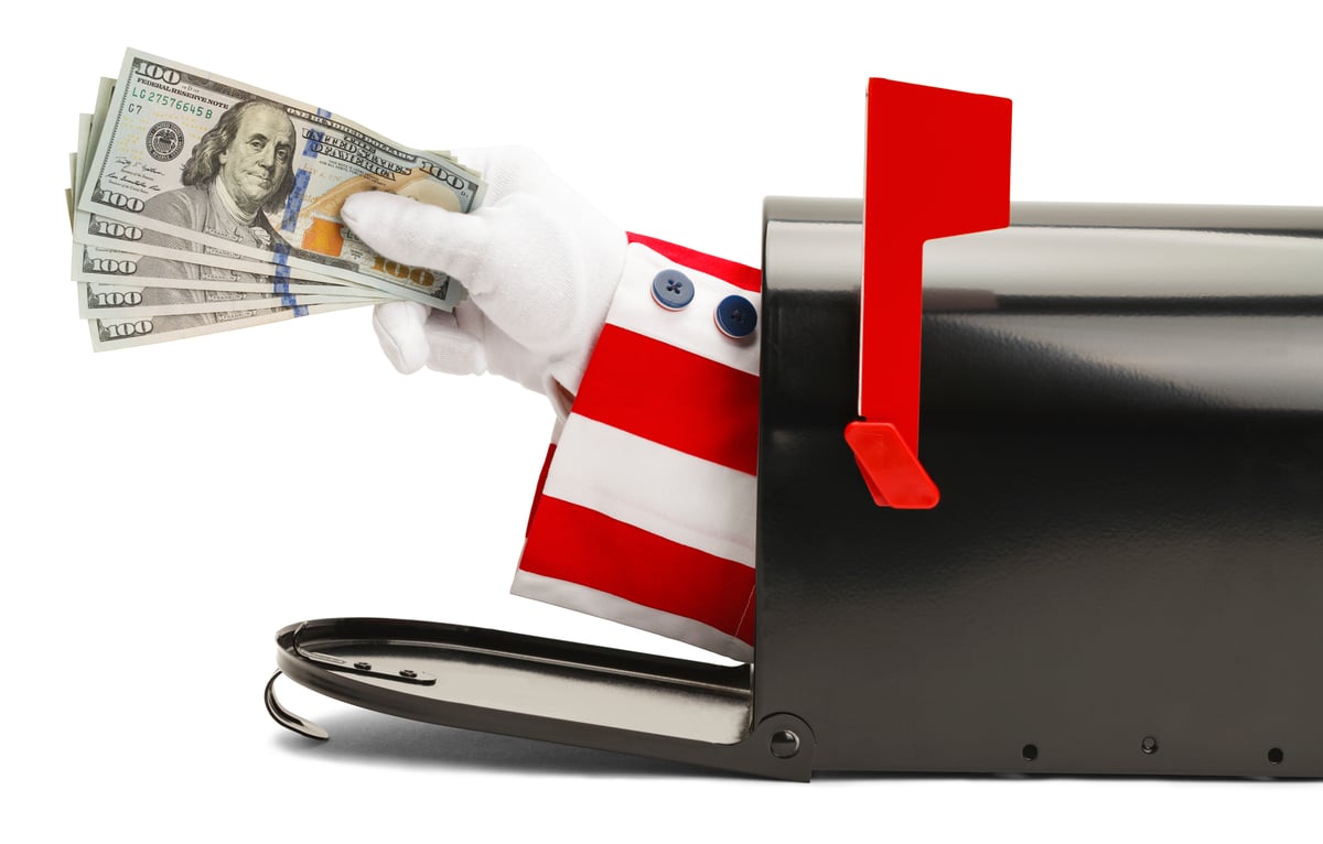 A red-and-white-striped sleeve and white-gloved hand sticking out of a mailbox and holding $100 bills.
