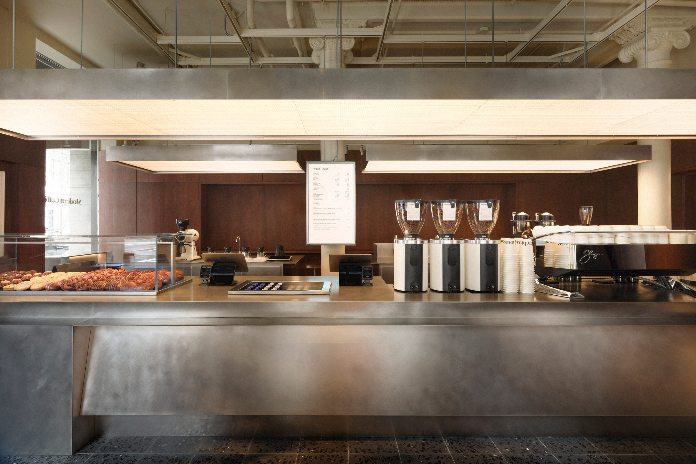 Polished steel counters run through the centre of a cafe
