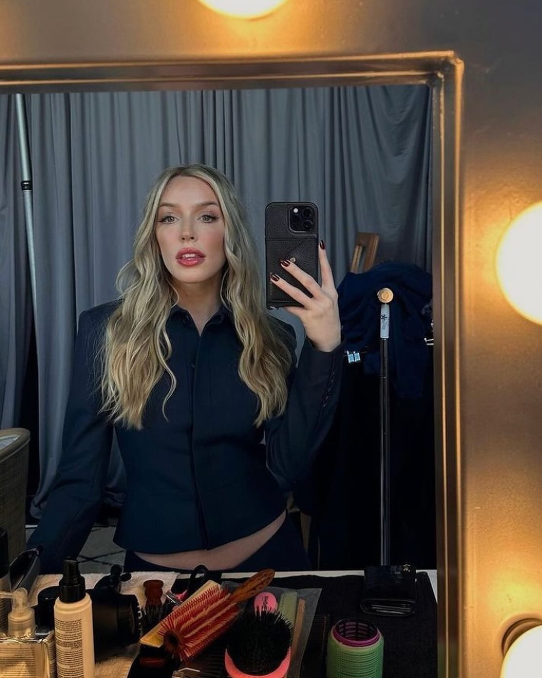 Alex Cooper taking a mirror selfie.