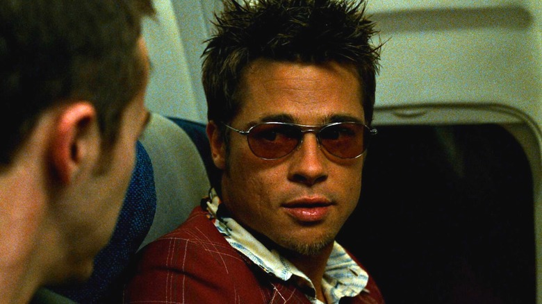 Brad Pitt as Tyler Durden on an airplane beside Edward Norton as the Narrator in Fight Club