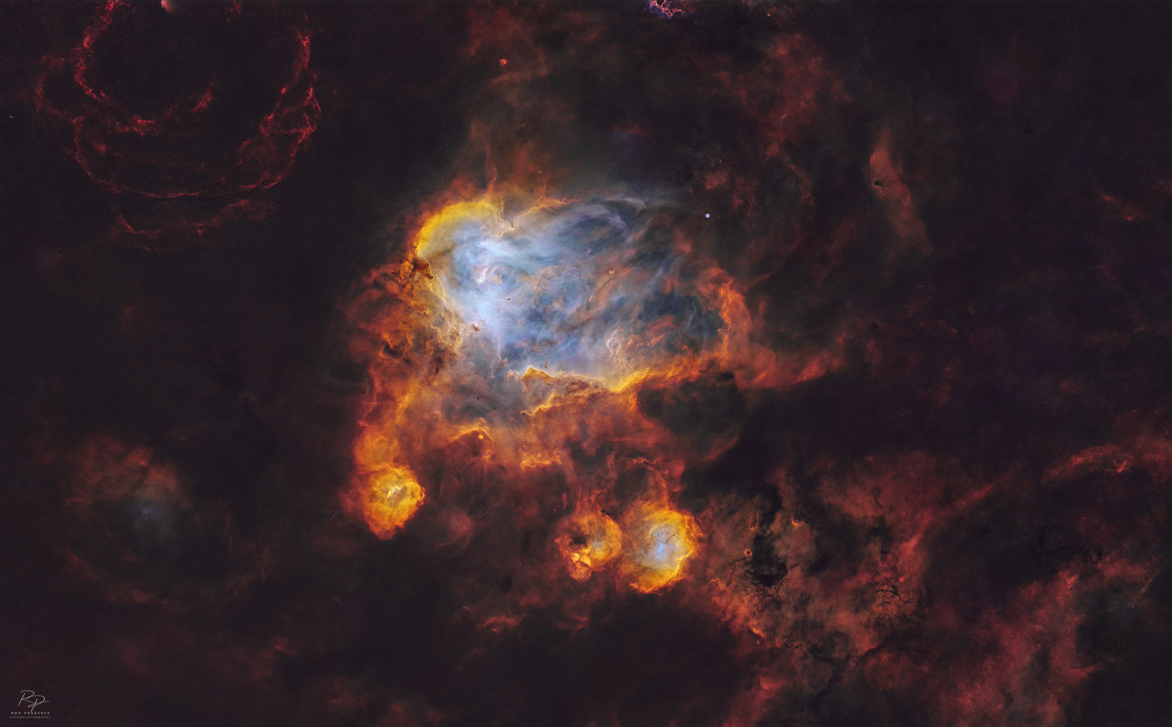 A deep space nebula scene is shown, featuring swirling masses of colorful interstellar gas and dense, dark dust filaments.