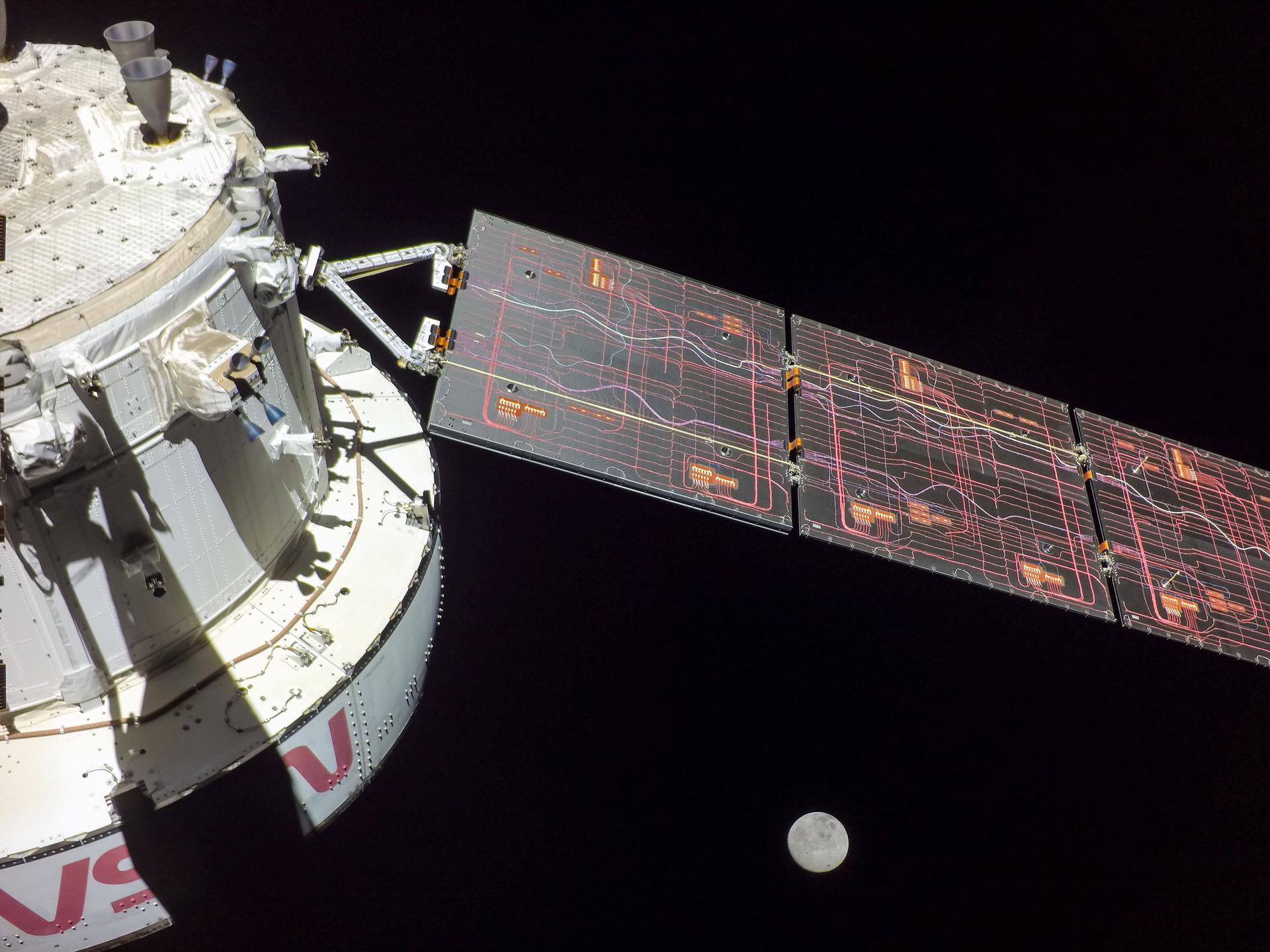 A photo of the Artemis I Orion capsule flying around the moon in 2022.