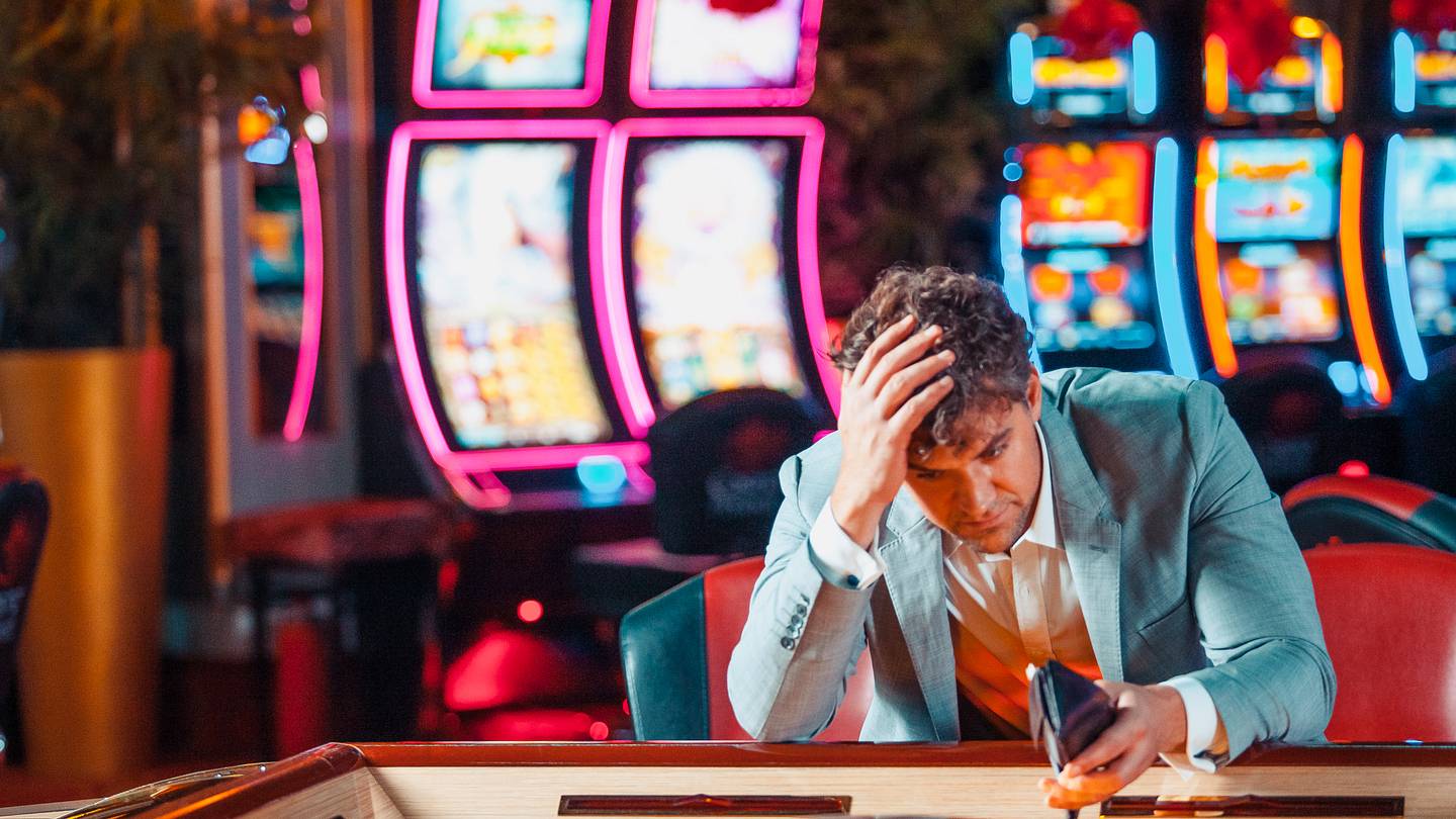 Mature men using smart phone for sports betting.