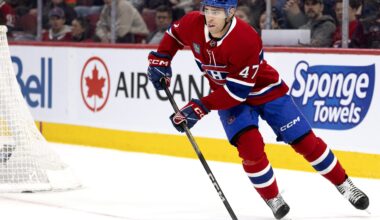 Hockey player with the puck behind the new.