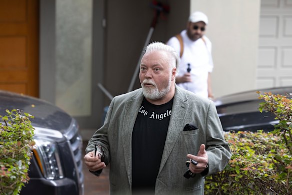 Sandilands’ manager Bruno Bouchet films Kyle Sandilands as he speaks to the press outside his home in March. 