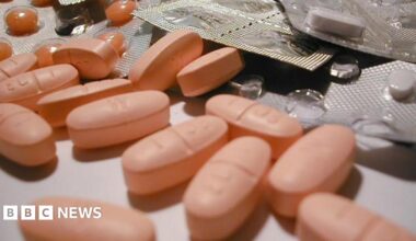 A generic image of pink pills on a counter, with some in blister packs.