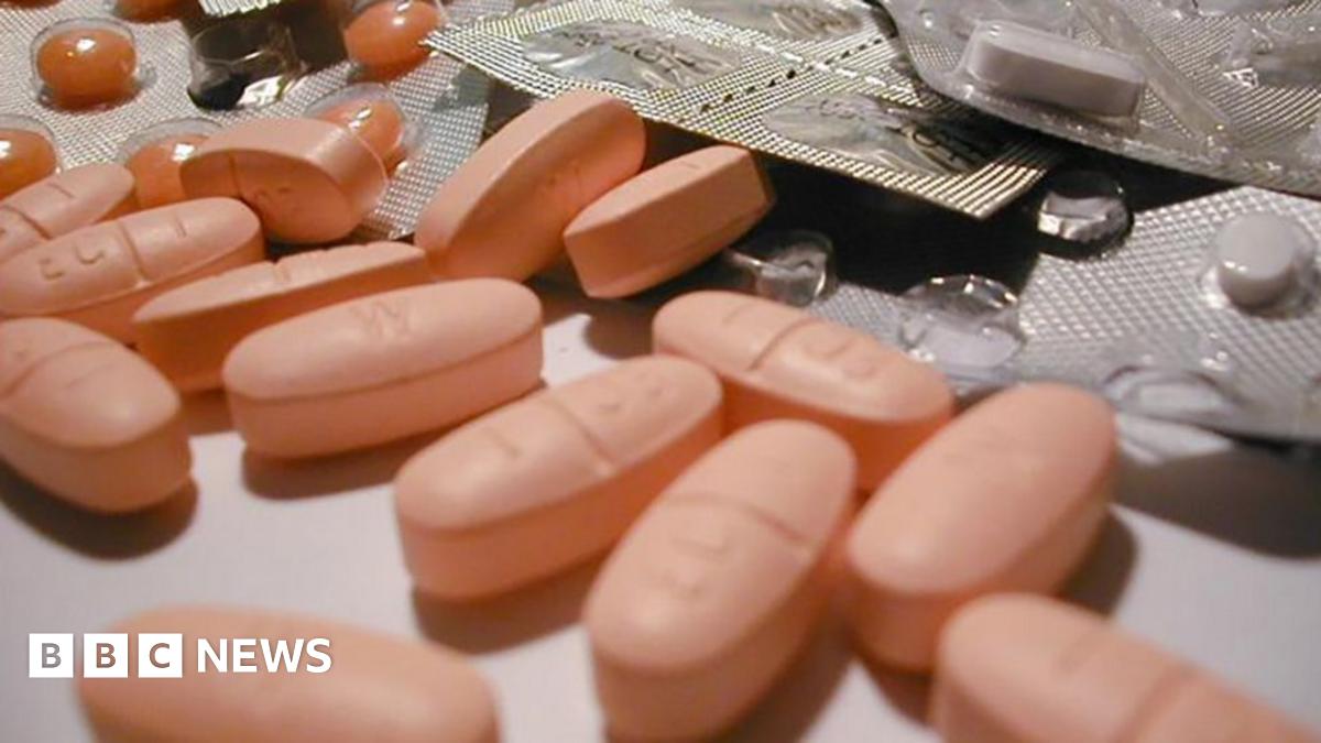 A generic image of pink pills on a counter, with some in blister packs.