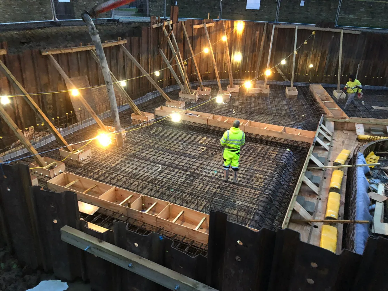 Construction workers building a semi-subterranean retirement home.