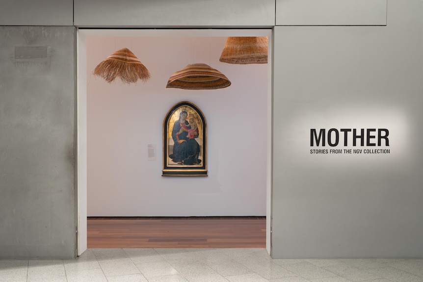 An image of the Madonna with child is framed in a doorway, with woven conical mats suspended fom the ceiling.
